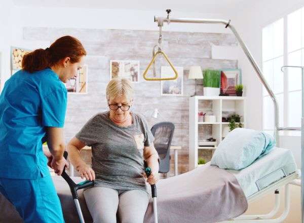 Caregiver Assisting Senior Woman in Home Setting, Promoting Home Care Services